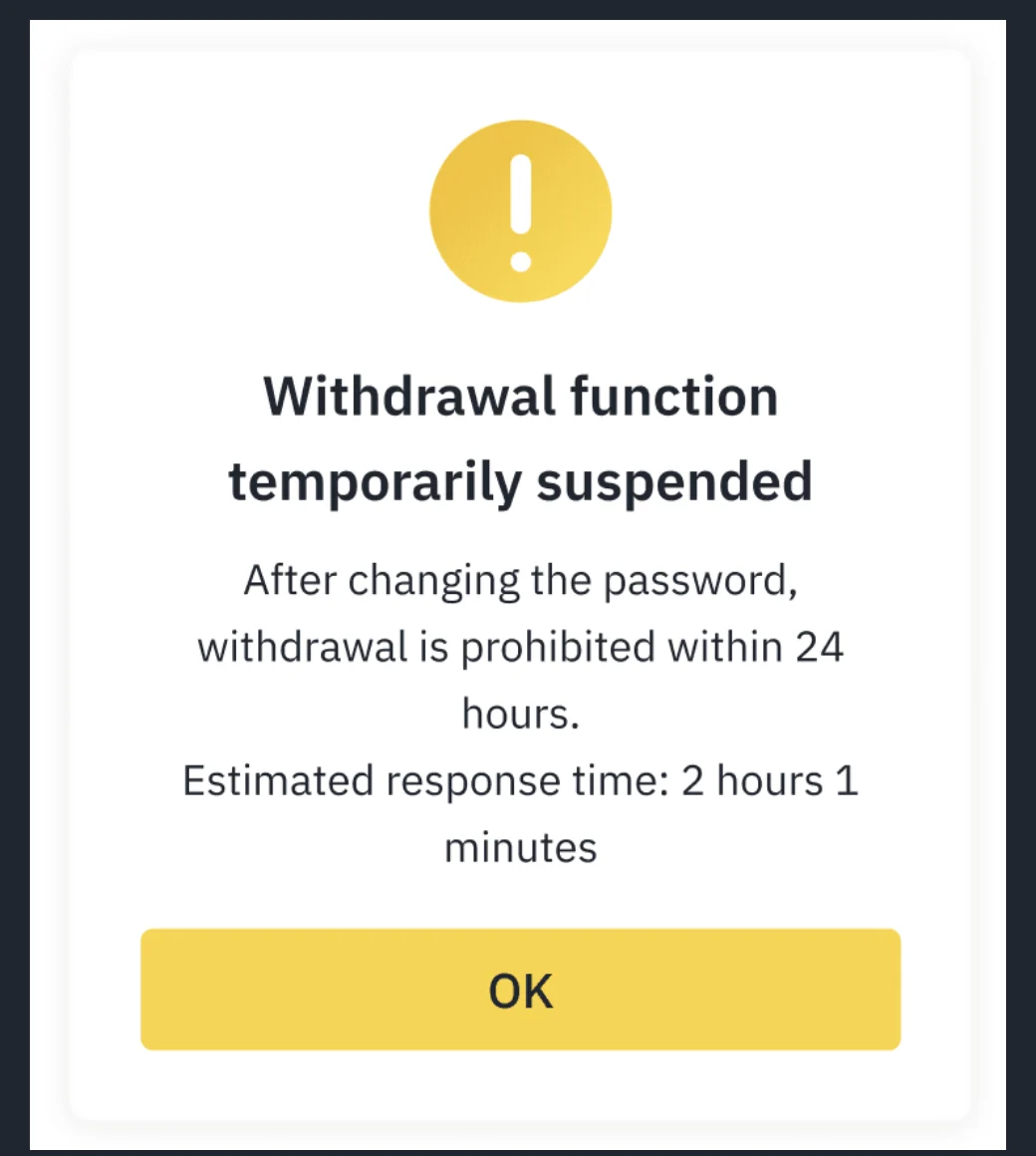 Binance in-app notice reading "Withdrawal function temporarily suspended", with the reason and an OK button